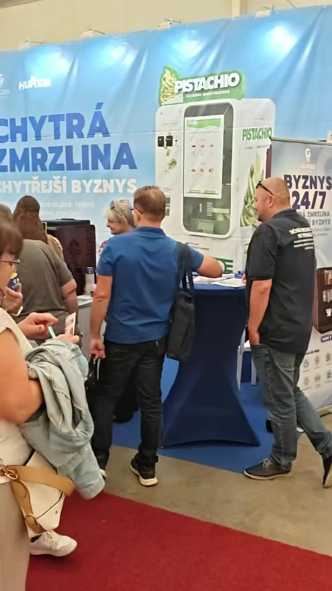 Food-service and ice cream professionals talking with the team at the ice cream vending machine booth in Prague